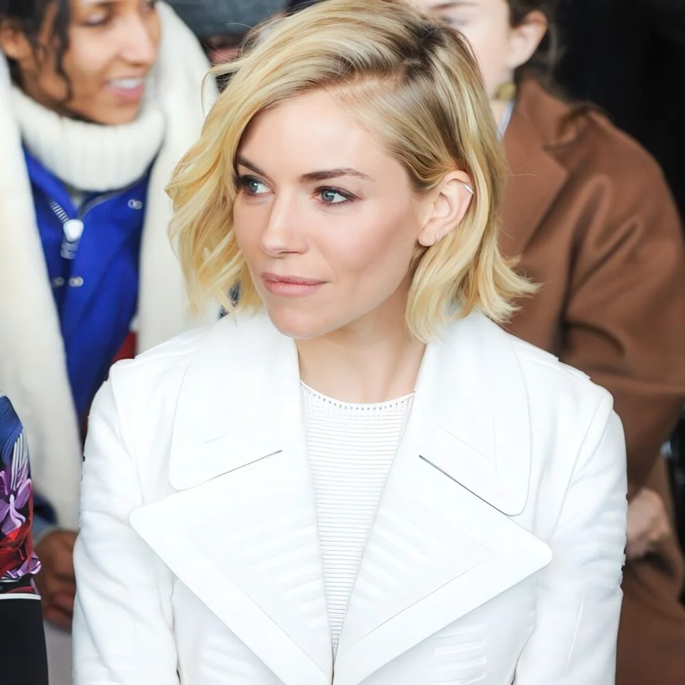 Side-parted blonde chin-length bob.