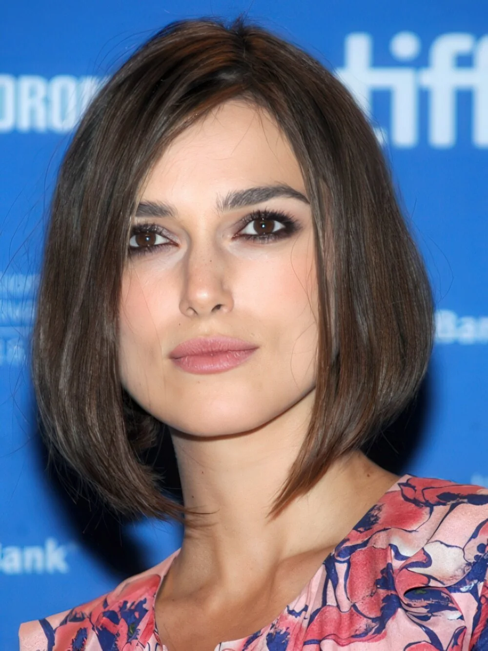 Sleek brunette chin-length bob with a center part.