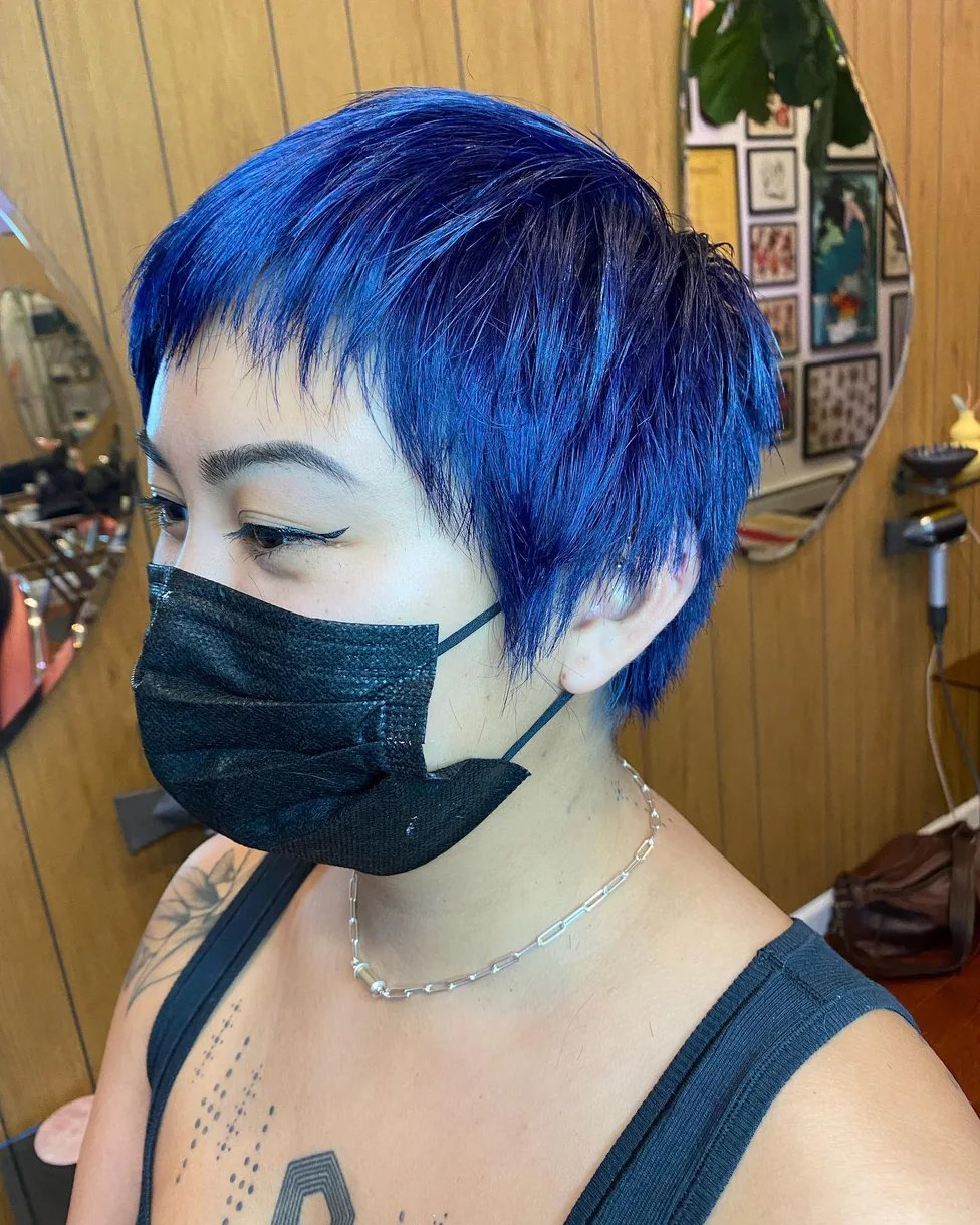 ear straight blue pixie with side swept fringe shown as a baby bangs idea