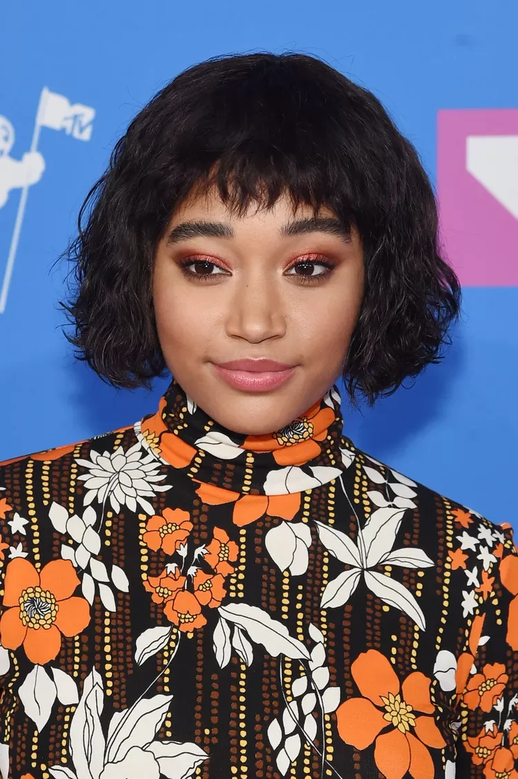 Curly bob with soft curly fringe and rounded face framing