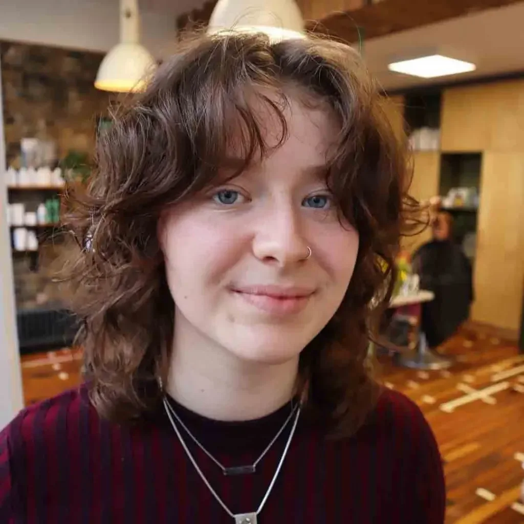 Curly short shag with soft fringe around a round face