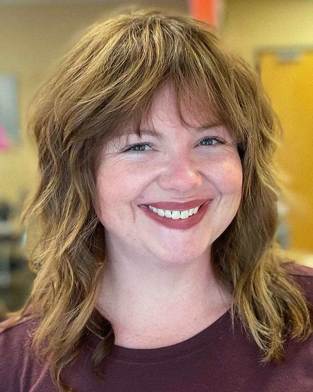 Copper shag haircut with curtain bangs for a round face