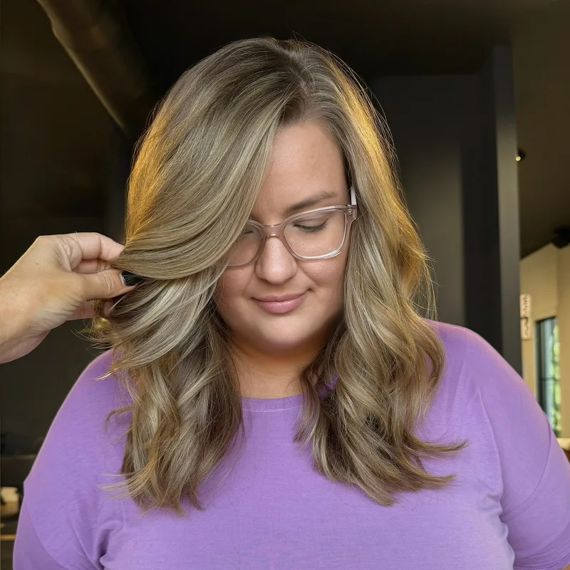 Shoulder-length highlighted hair with soft curled ends
