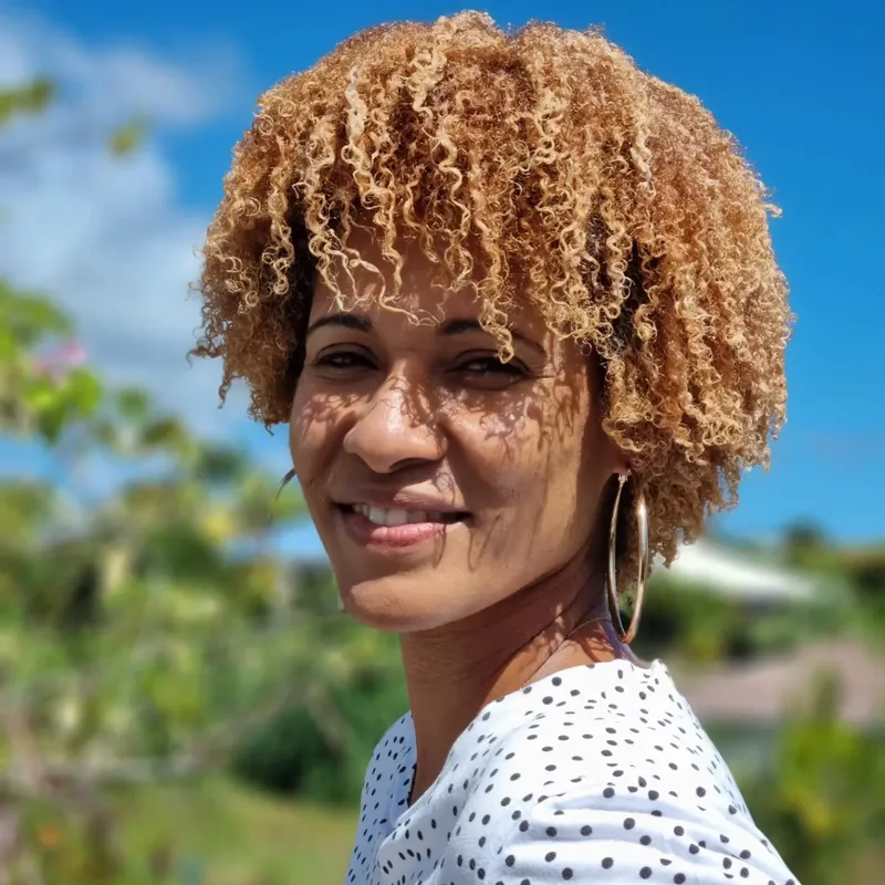 Golden natural coils with a tapered side, shown as hairstyle inspiration.