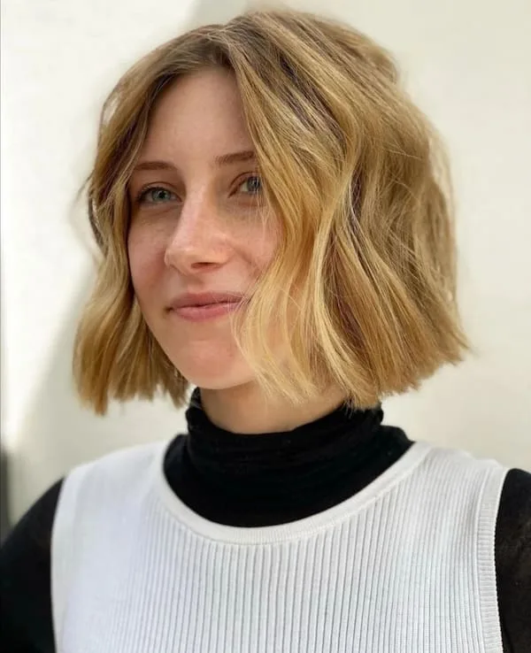 Blonde chin-length bob with loose natural-looking bends, shown as hairstyle inspiration.