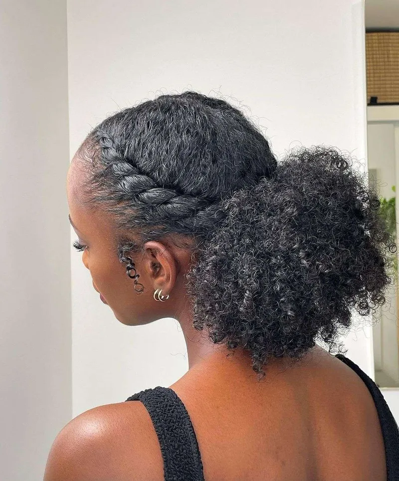 Back view of a braided natural updo with a textured puff