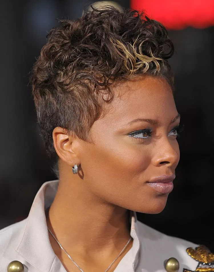 Woman with a short tightly curled top and closely cropped sides