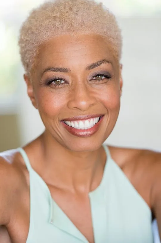 Woman with a short blonde hairstyle and neatly arranged hairline