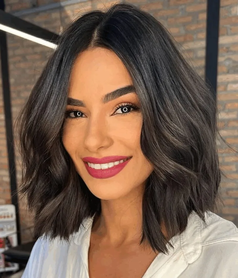 Dark shoulder-length hair with full shaped ends