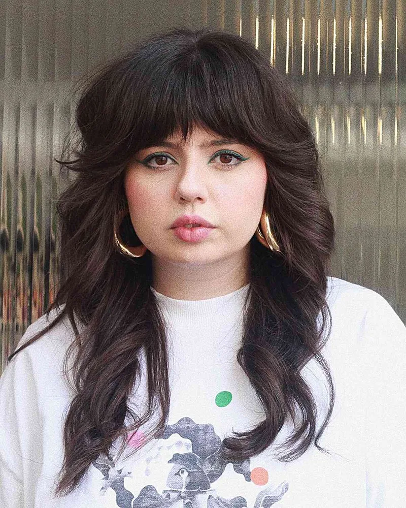 Long dark hair with a fringe and layered ends