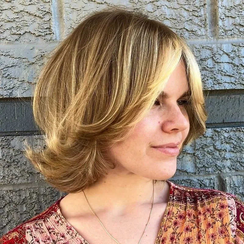 Blonde bob with swept layers and rounded side volume