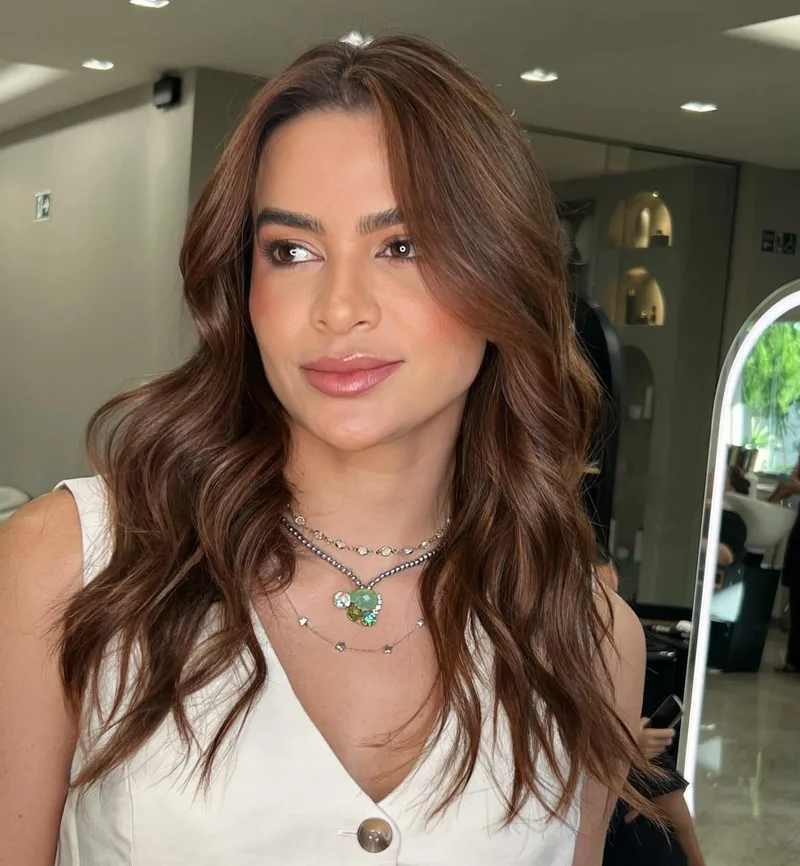 Long brown hair styled in large loose waves