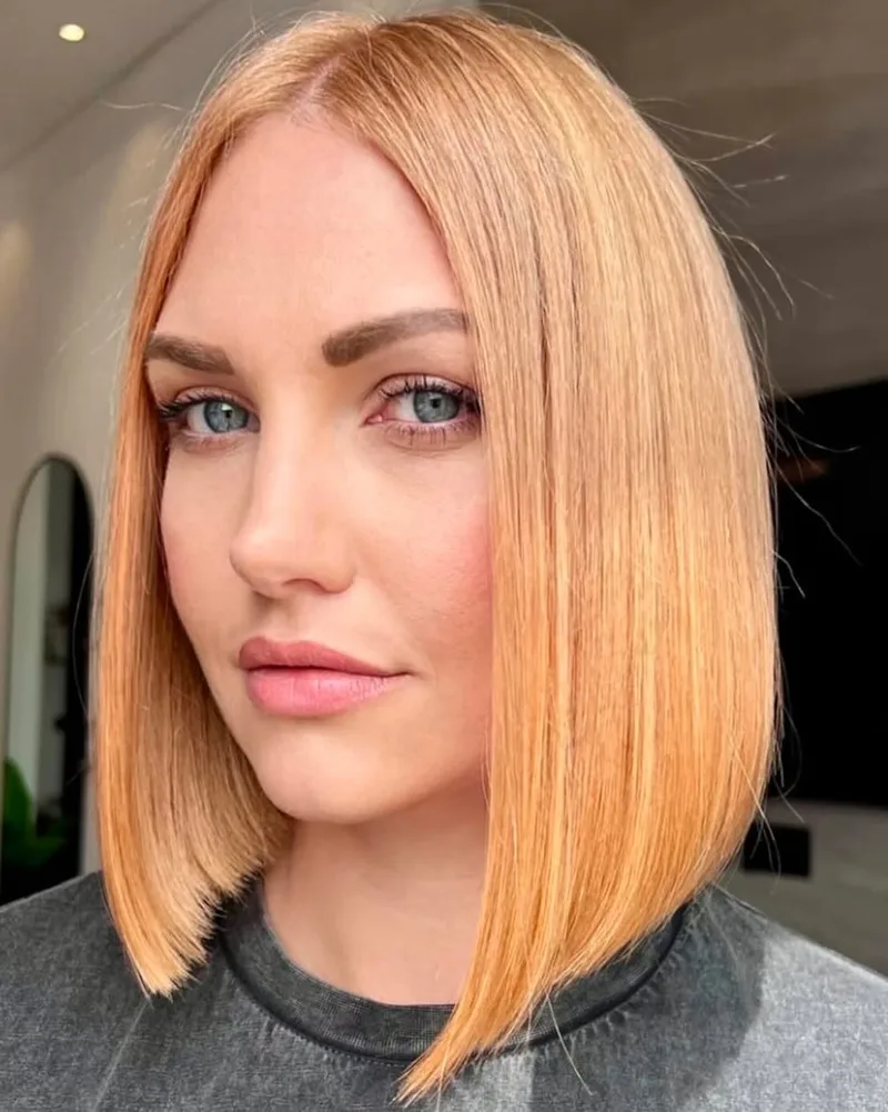 Sleek copper blunt bob with a precisely finished outline
