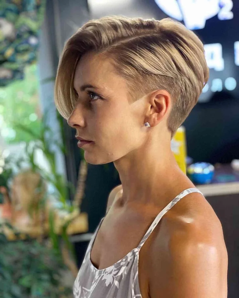Short blonde pixie with an exposed closely clipped side