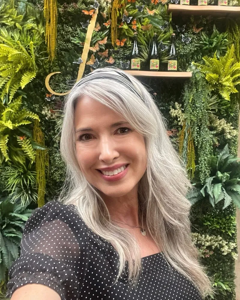 Woman with silver long layers outdoors