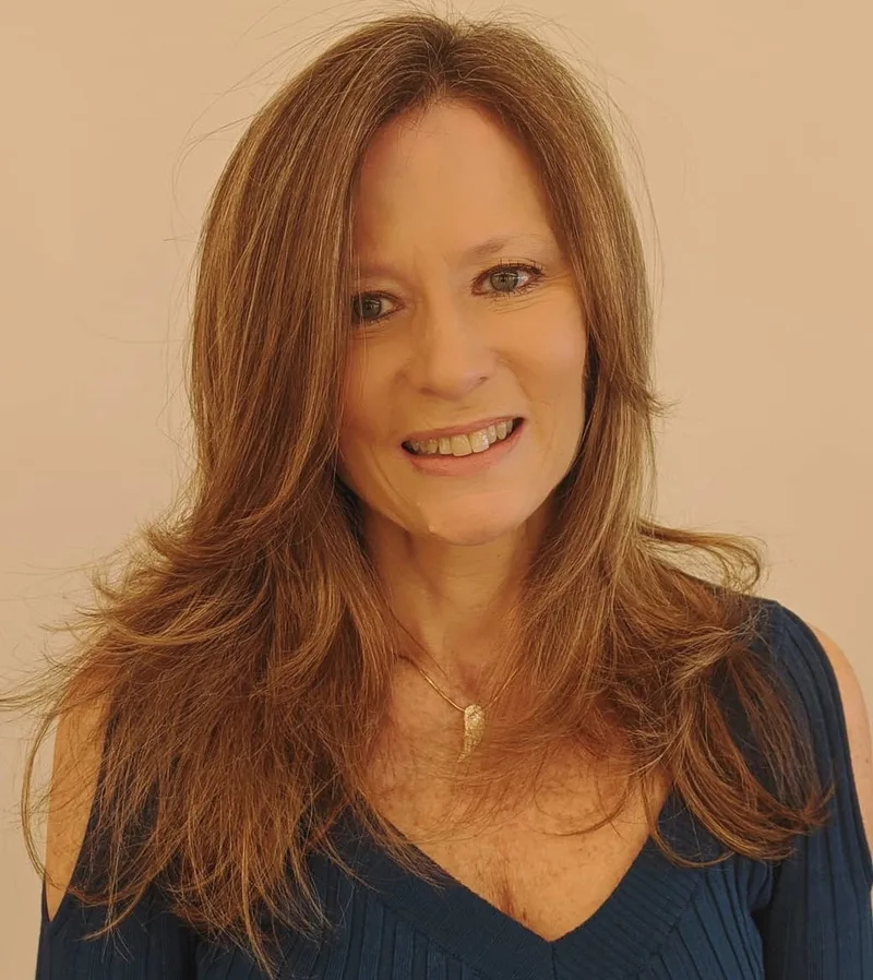 Woman with long red layers and curved ends