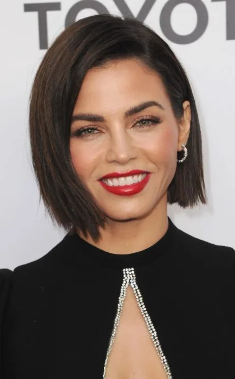Smooth chin-length brunette bob with a side part