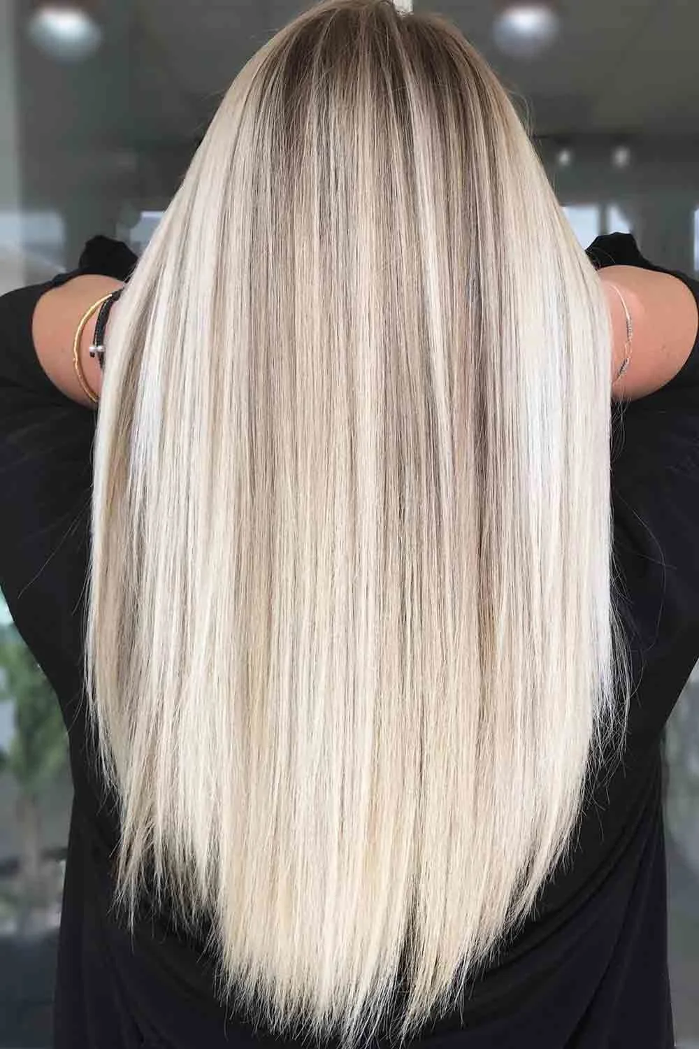 Long straight pale blonde hair with darker fine ribbons and shaded roots