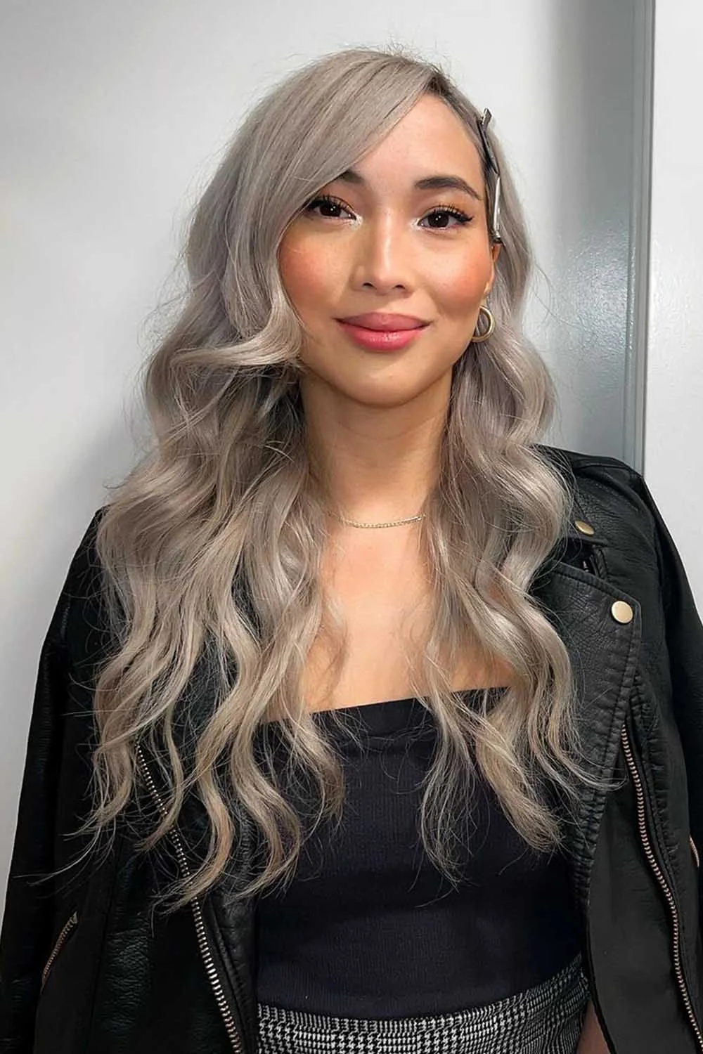 Long silver-blonde waves framing the face with a side opening