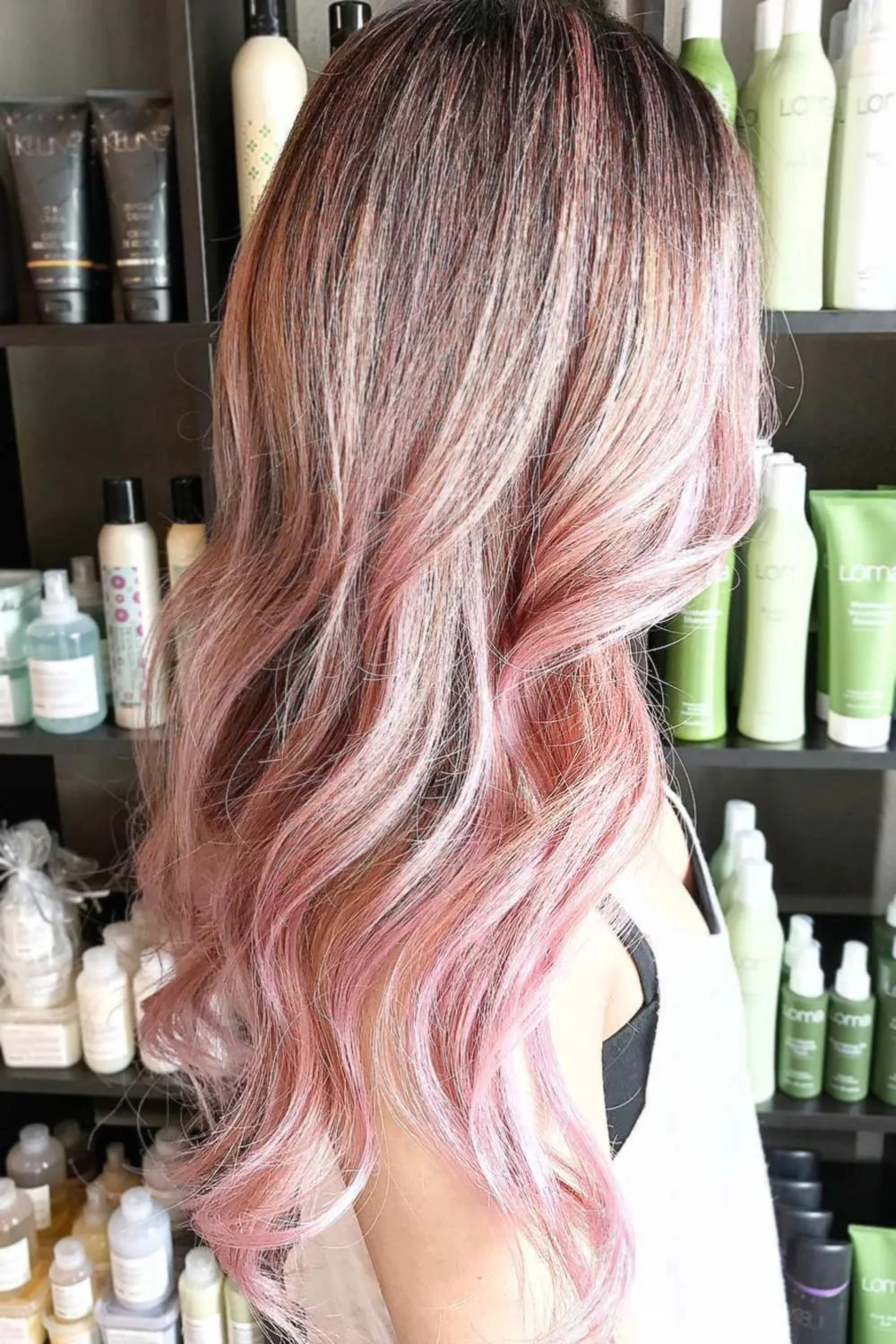 Long waves blending a darker crown into light blonde and pastel pink ends