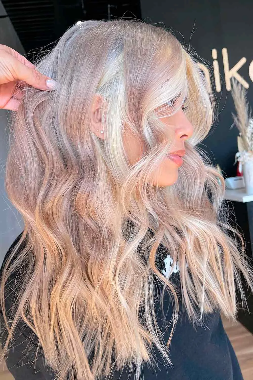 Pale blonde waves with a faint pink tint near the front