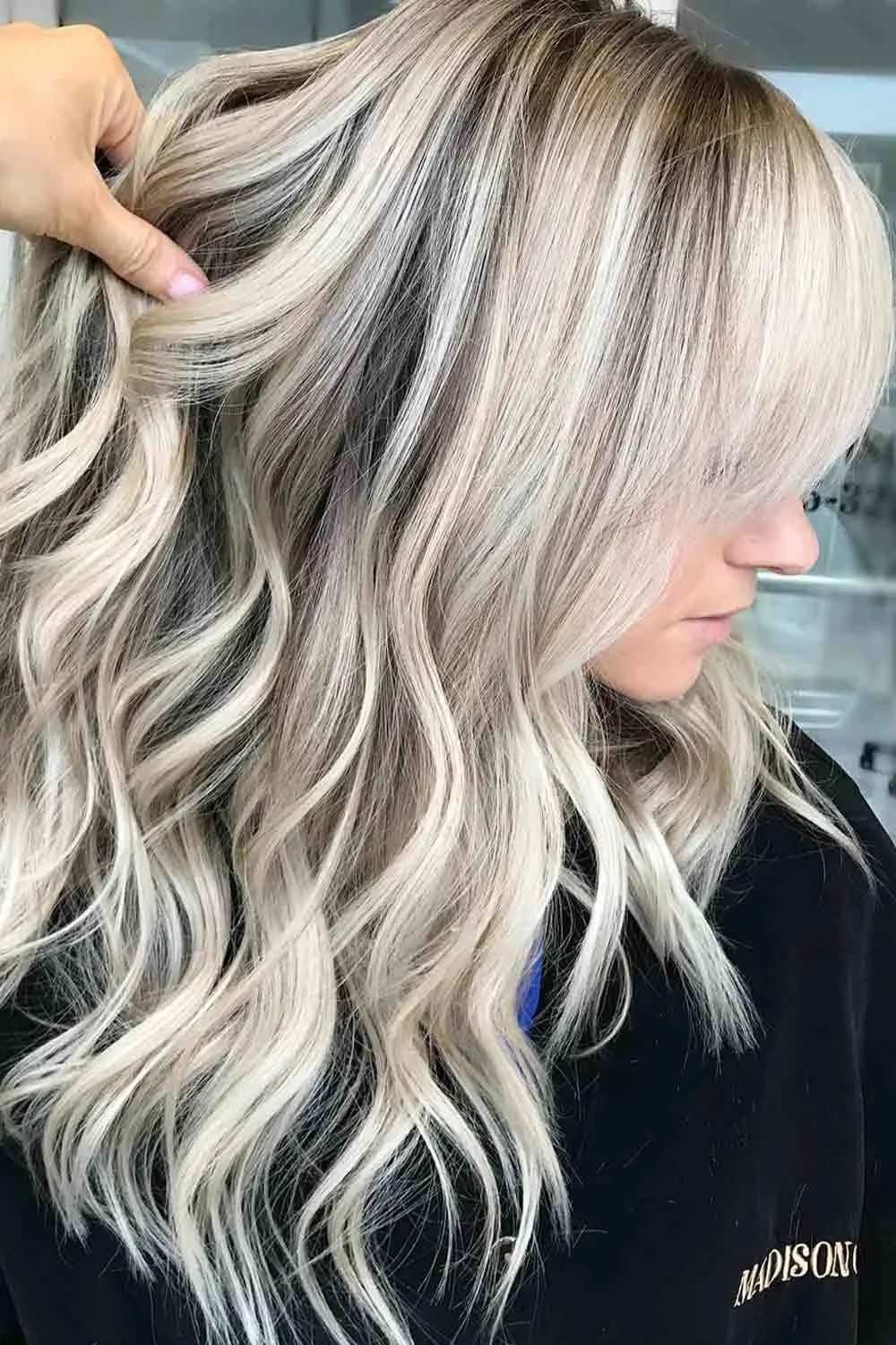 Ash blonde waves showing pale ribbons against a darker upper area