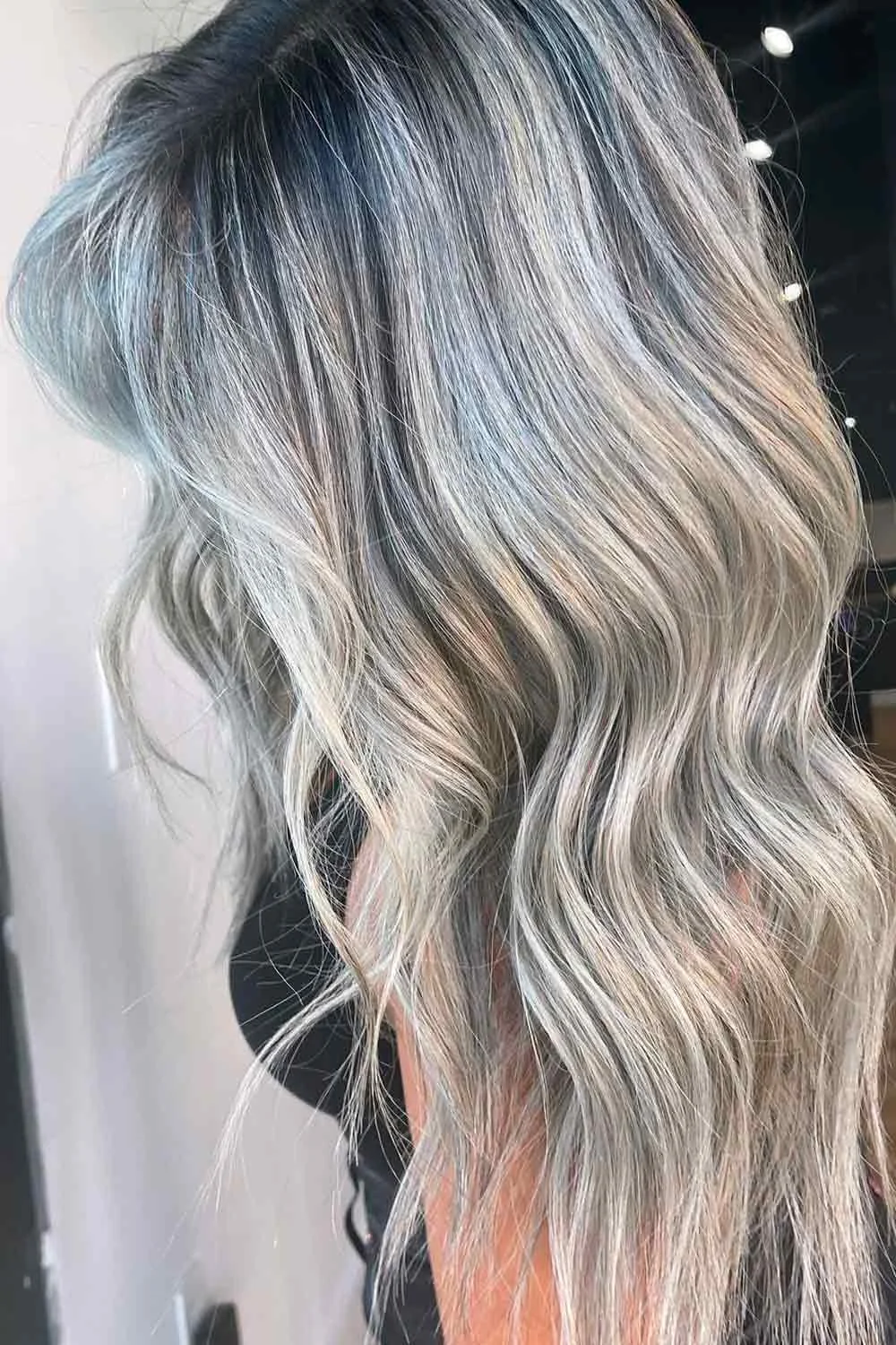 Back view of cool silver-blonde waves with a shaded root area