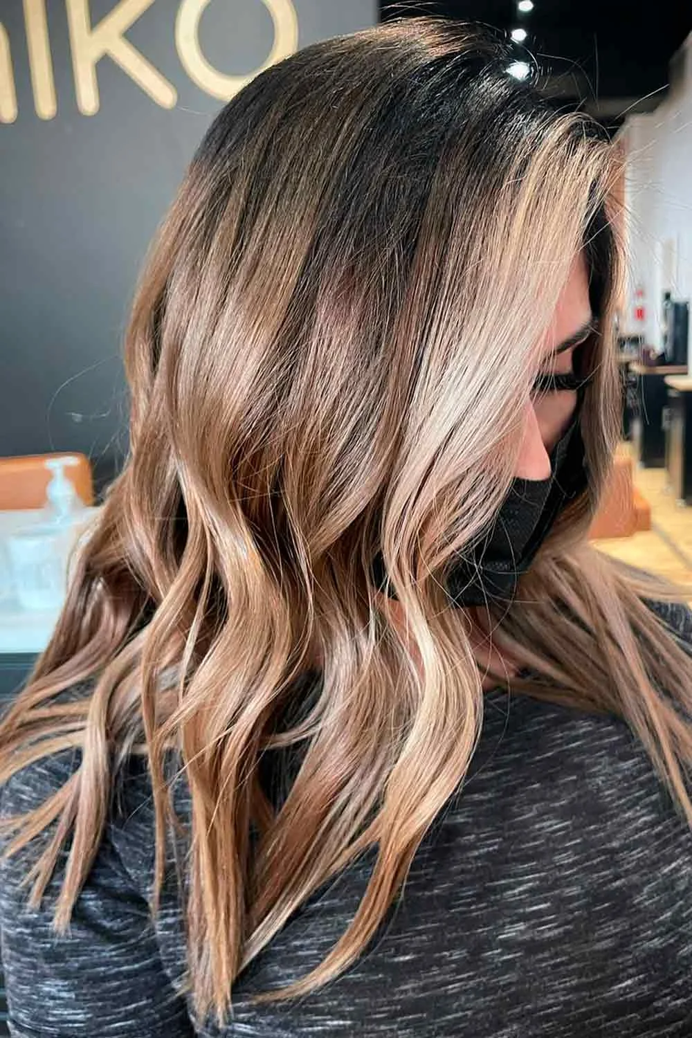Side view of brown-blonde hair with lighter face-side ribbons and waves