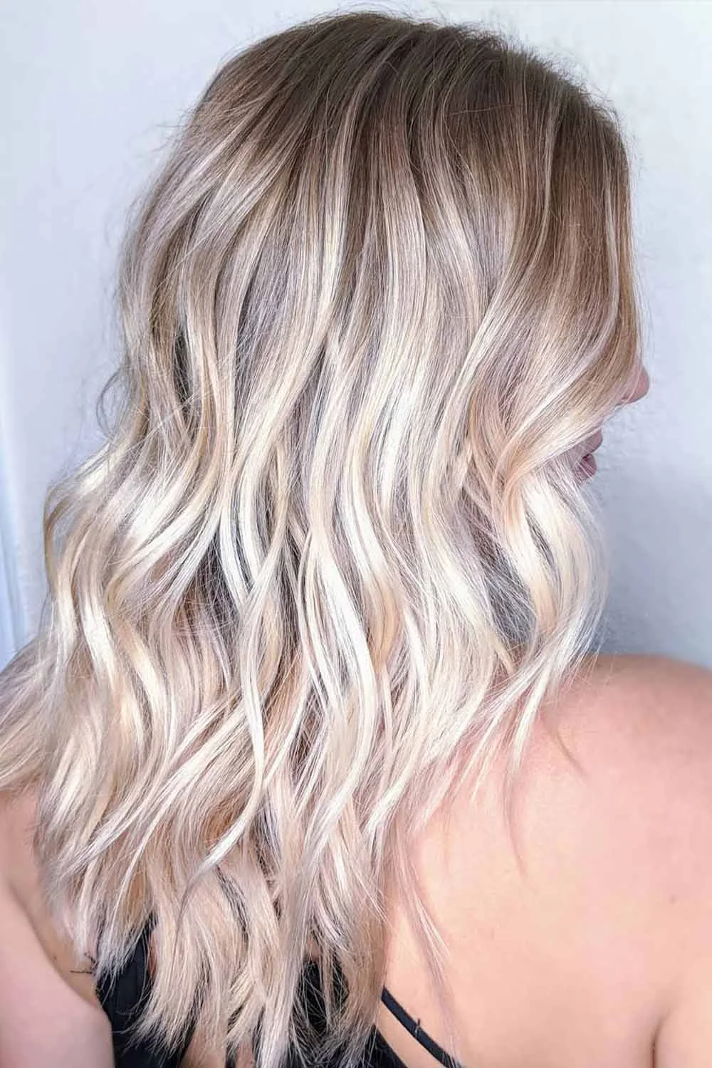 Back-side view of shoulder-length waves changing from brown to pale blonde