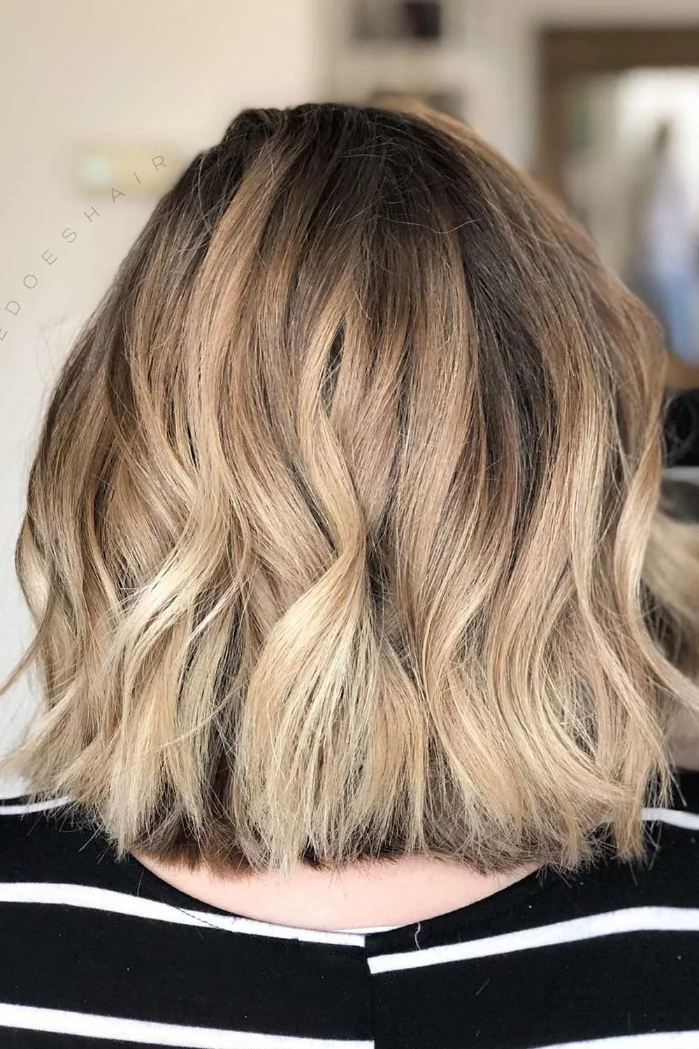 Back view of a wavy lob with a darker crown and warm blonde ends