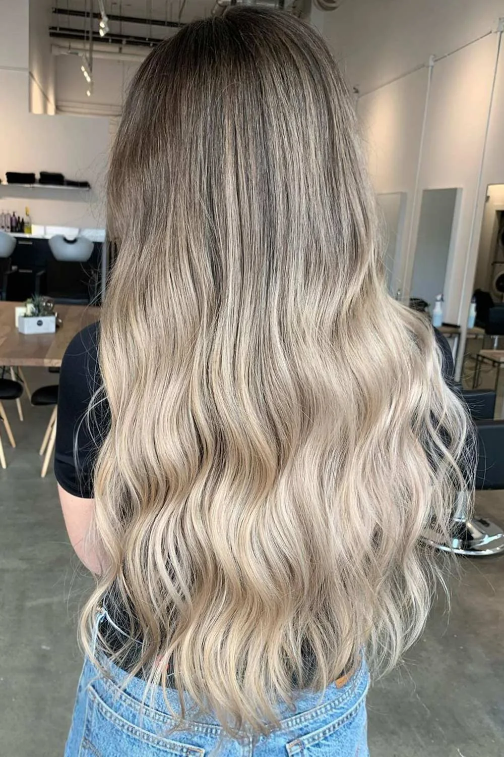 Back view of long hair with a brown crown gradually changing to pale blonde