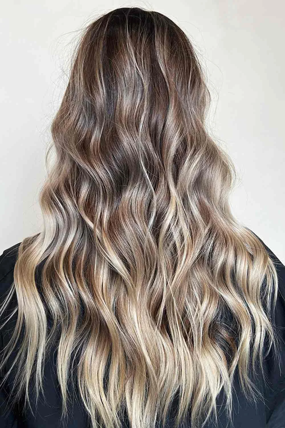 Back view of long wavy hair with brown upper lengths and pale blonde ends