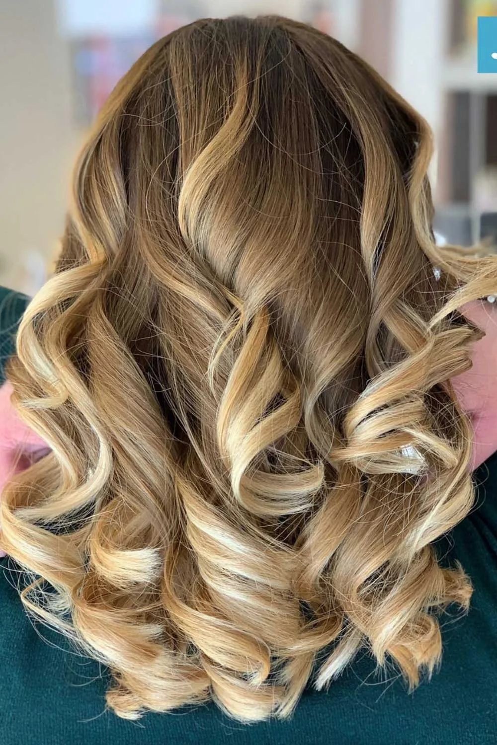 Back-side view of long golden blonde curls beneath darker brown upper hair