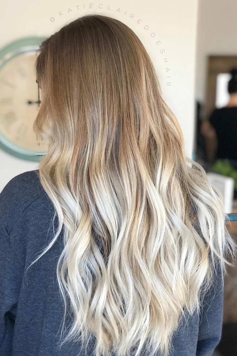 Back-side view of long hair with a brown root area fading into pale blonde