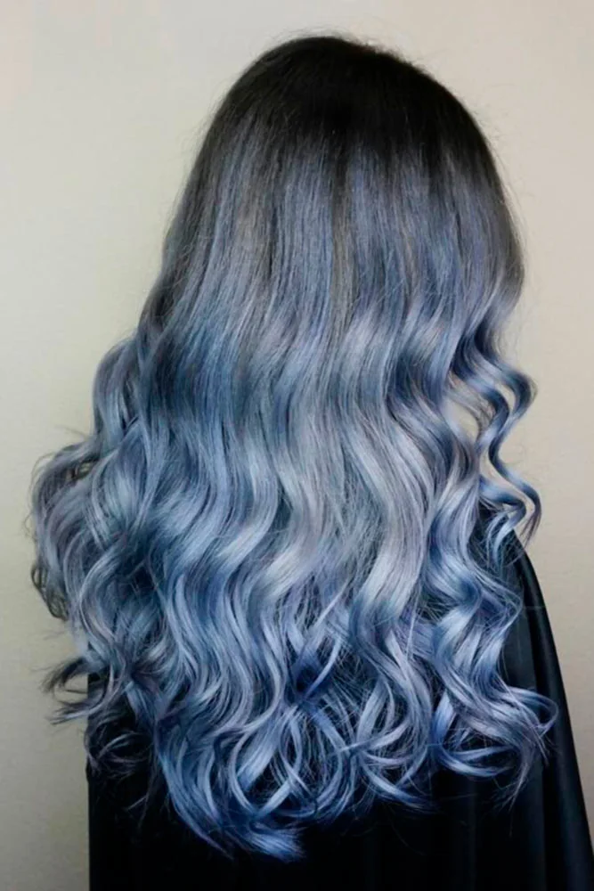 Back view of dark hair fading into muted denim-blue long curls