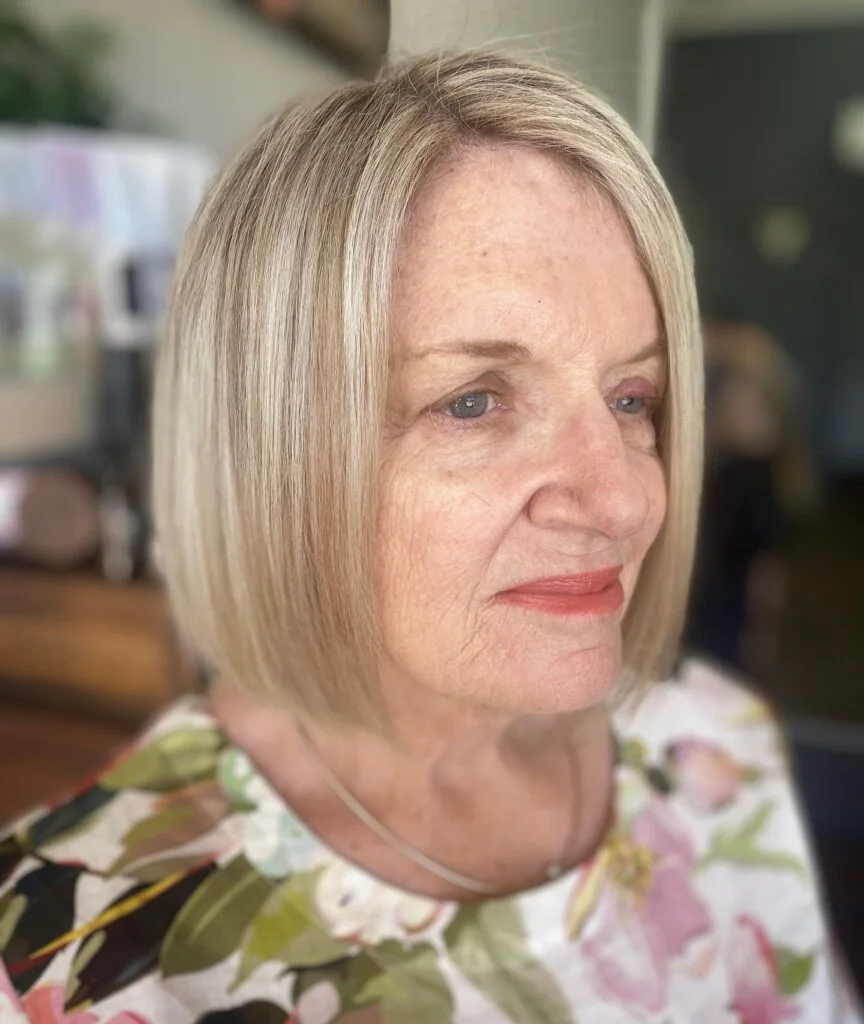 Straight blonde neck-length bob with a clean side line