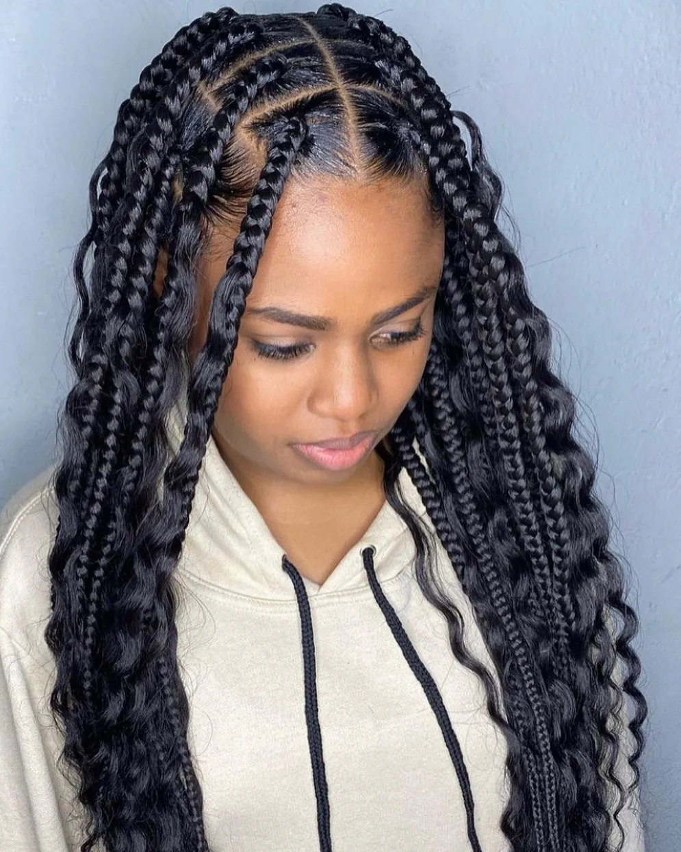chest braids black knotless shown as a box braids hairstyles styling ideas idea, featuring black color, shown in black woman boho box braids with loose curls