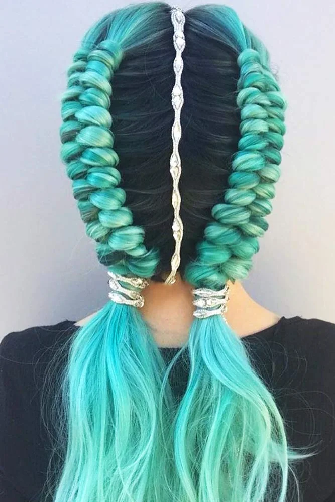 Back view of turquoise twin looped braids with a silver center accent and decorative bands