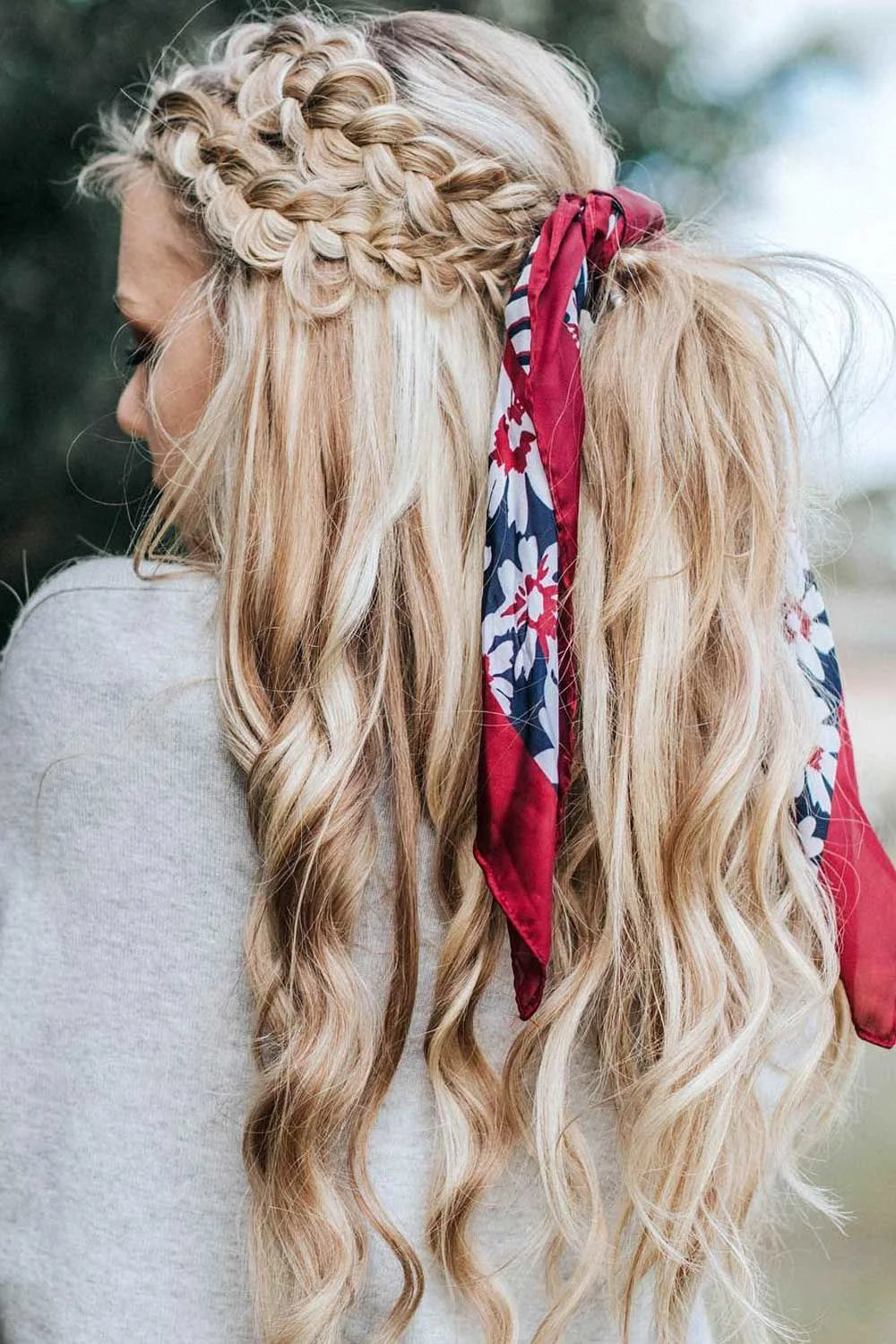 Back-side view of blonde half-up braids with a long printed scarf at the join