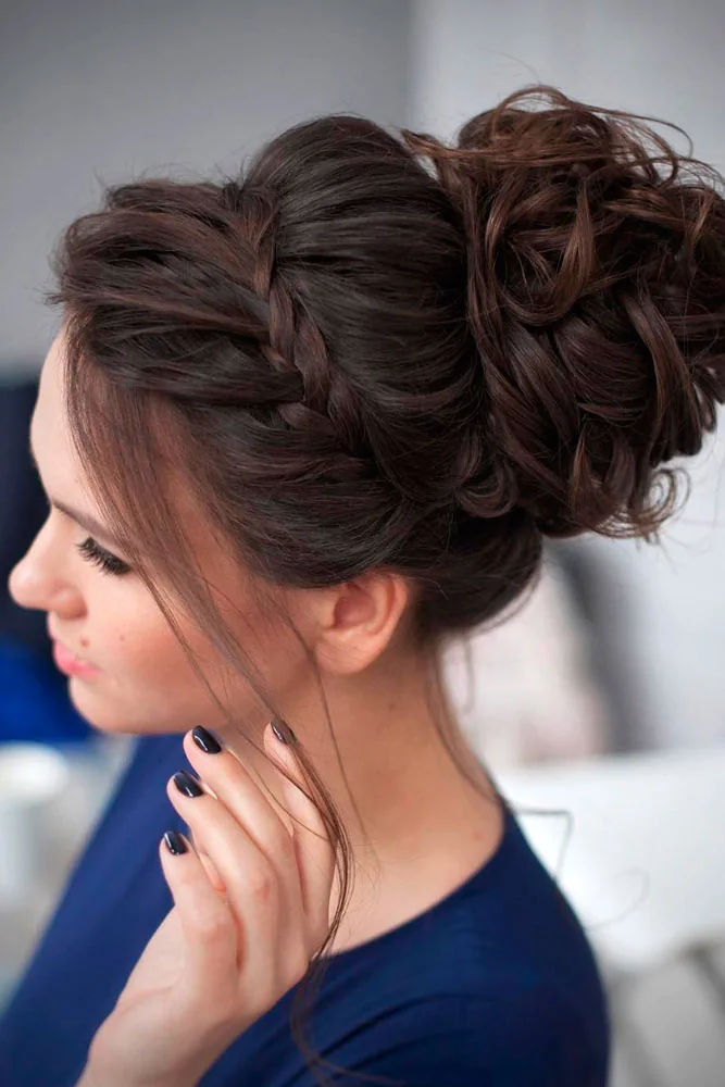 Side view of a brunette updo with a twisted side section and a full lifted bun