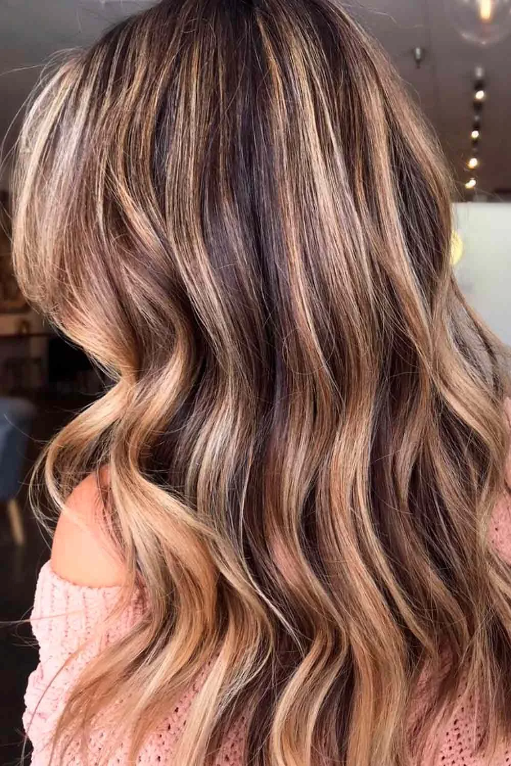 Back-side view of soft brown waves with pale warm highlight ribbons