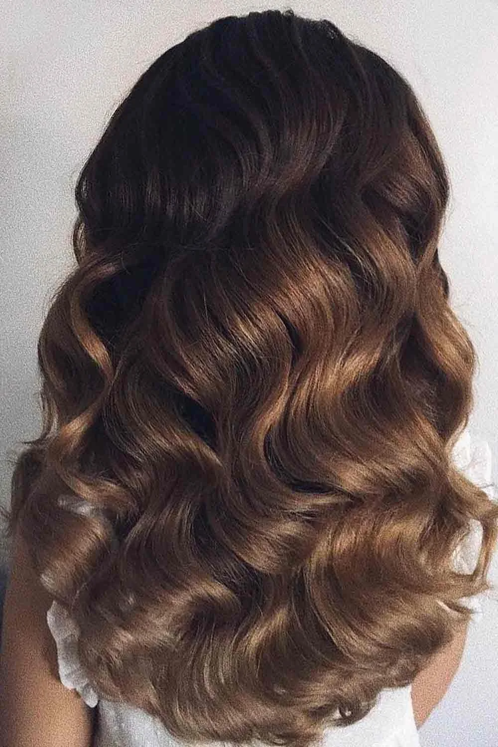 Back view of glossy brown waves with subtle golden-brown accents