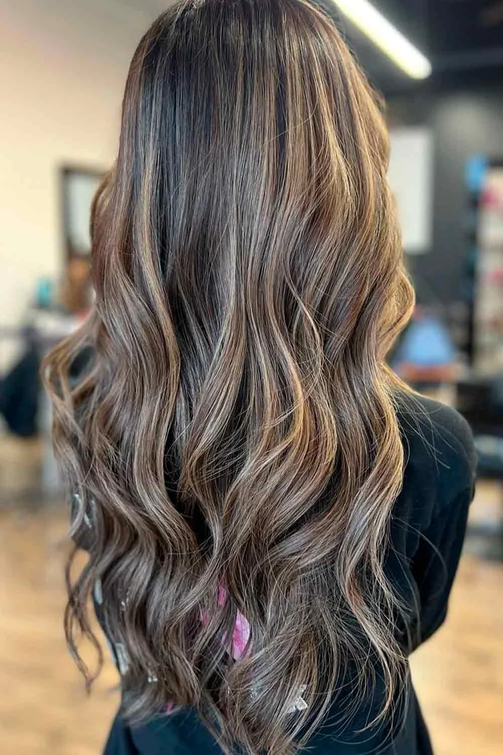 Back view of long very dark brown waves with slim lighter ribbons