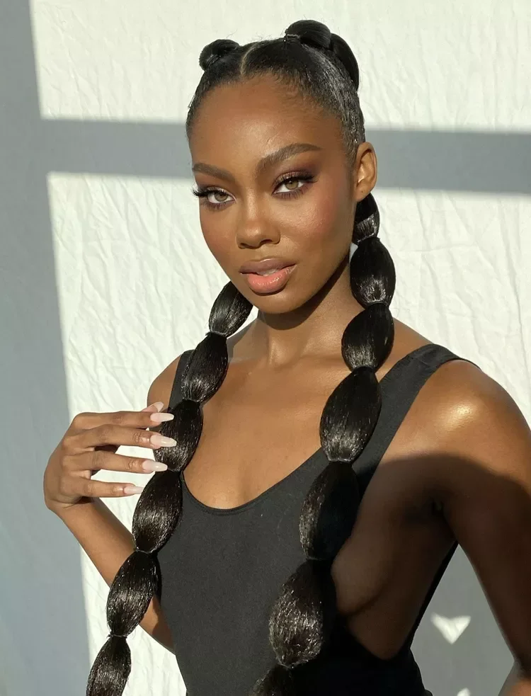 Front view of extra long black double bubble braid ponytails