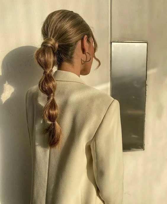 chest straight chestnut ponytail shown as a bubble braid ponytail hairstyles idea, featuring volume through the low volume