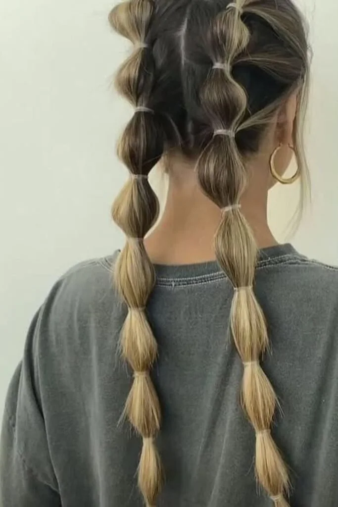 chest straight chestnut bubble pigtails shown as a bubble braid ponytail hairstyles idea, featuring volume through the low volume