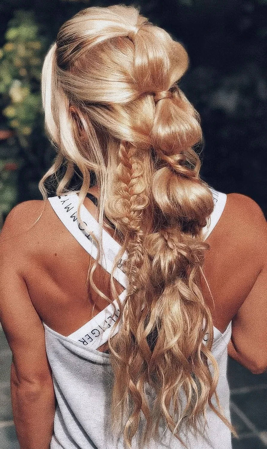 Complicated hairstyle with a bubble braid and some smaller loose braids, waves down and face-framing hair.