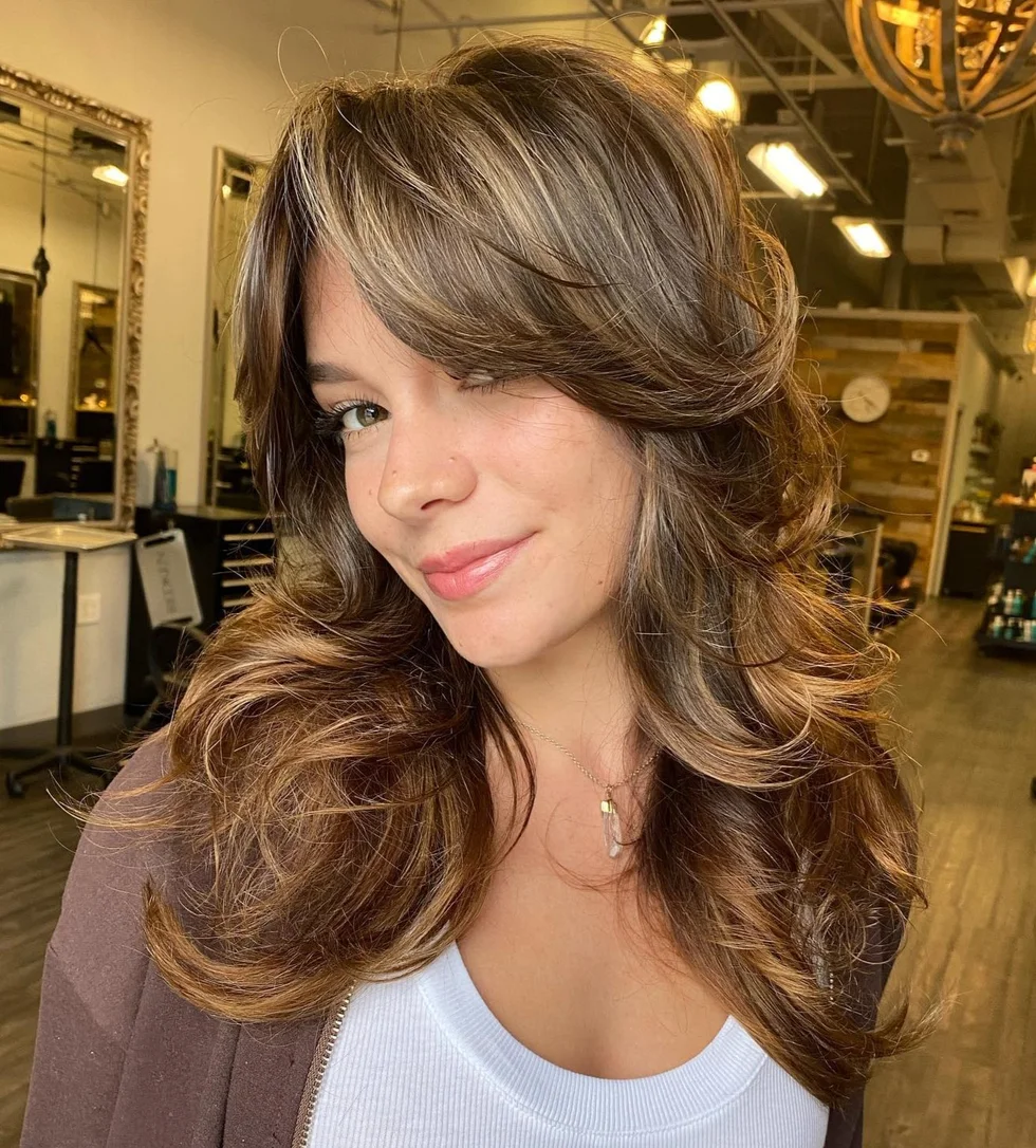 Glossy brunette butterfly haircut with feathered long layers