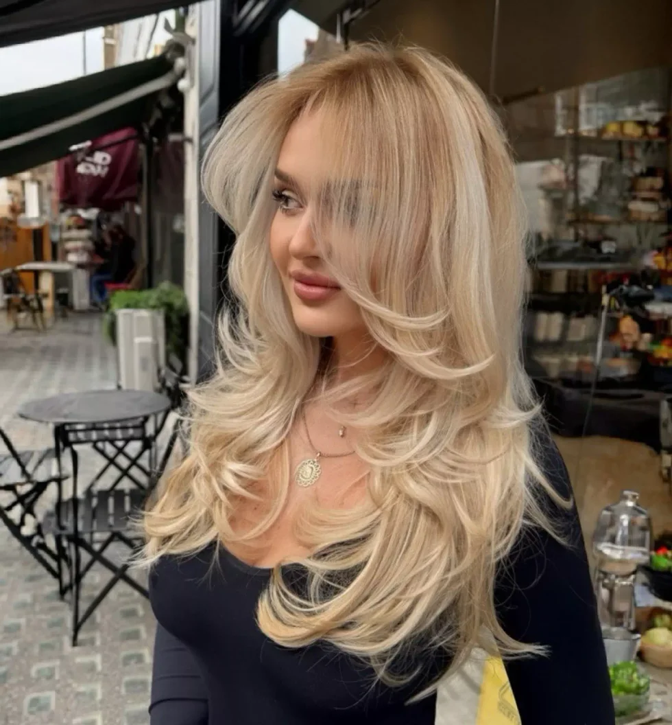 Champagne blonde butterfly haircut with long blowout layers