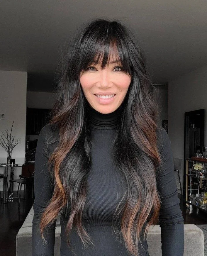 Long butterfly haircut with soft fringe and face-framing layers